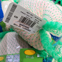 A product label on a frozen turkey showing the net weight, price, and barcode.